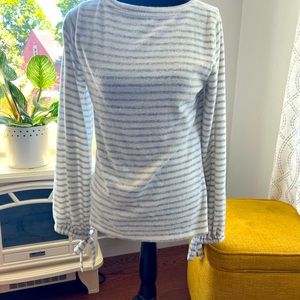 Grey and white striped warm fleece like sweater with ties on end of sleeves